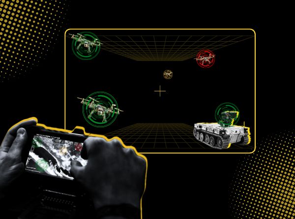 Hands holding a controller, in front of a screen that has multiple robotic vehicles and a targeted drone